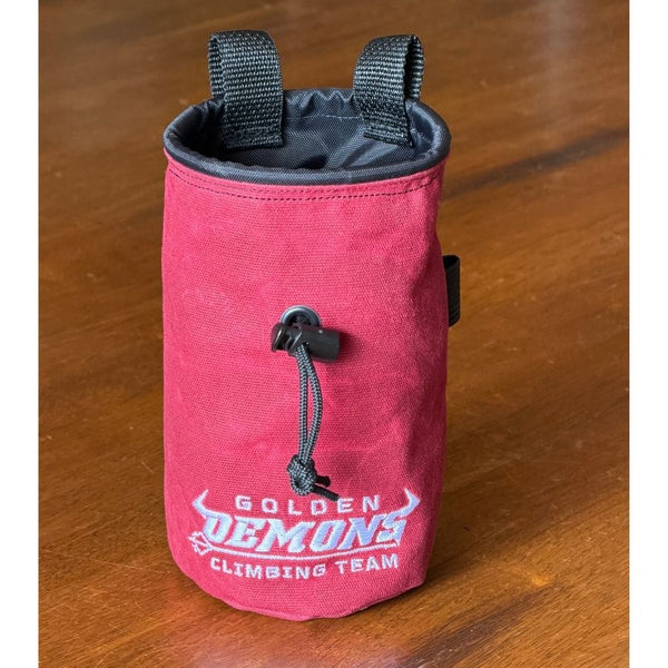 Maroon GHS Climbing waxed canvas chalk bag with embroidered Golden Demons logo and black drawcord.