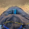 whitewater gear bag open and draped over raft tubes for easy loading