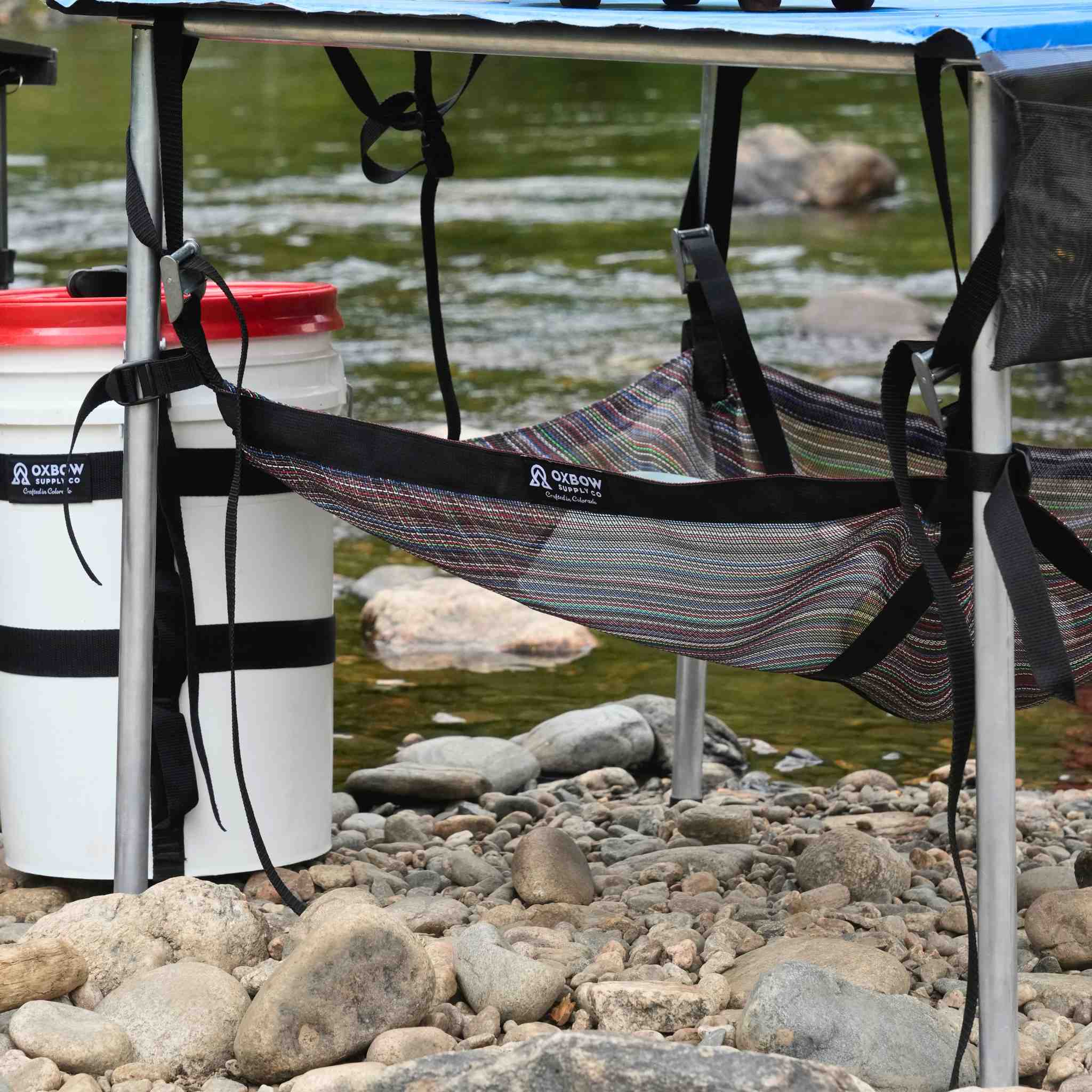 Oxbow Table Sling mounted beneath folding camp table