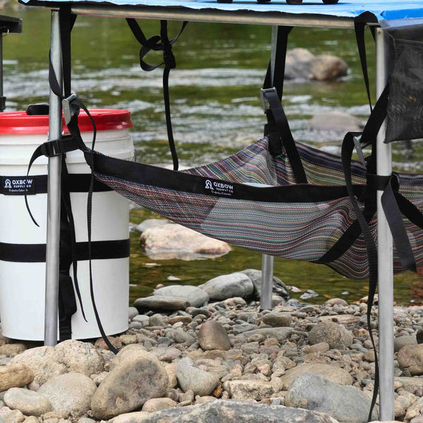 Oxbow Table Sling mounted beneath folding camp table