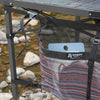 Camp table storage bag attached to folding table with cam straps
