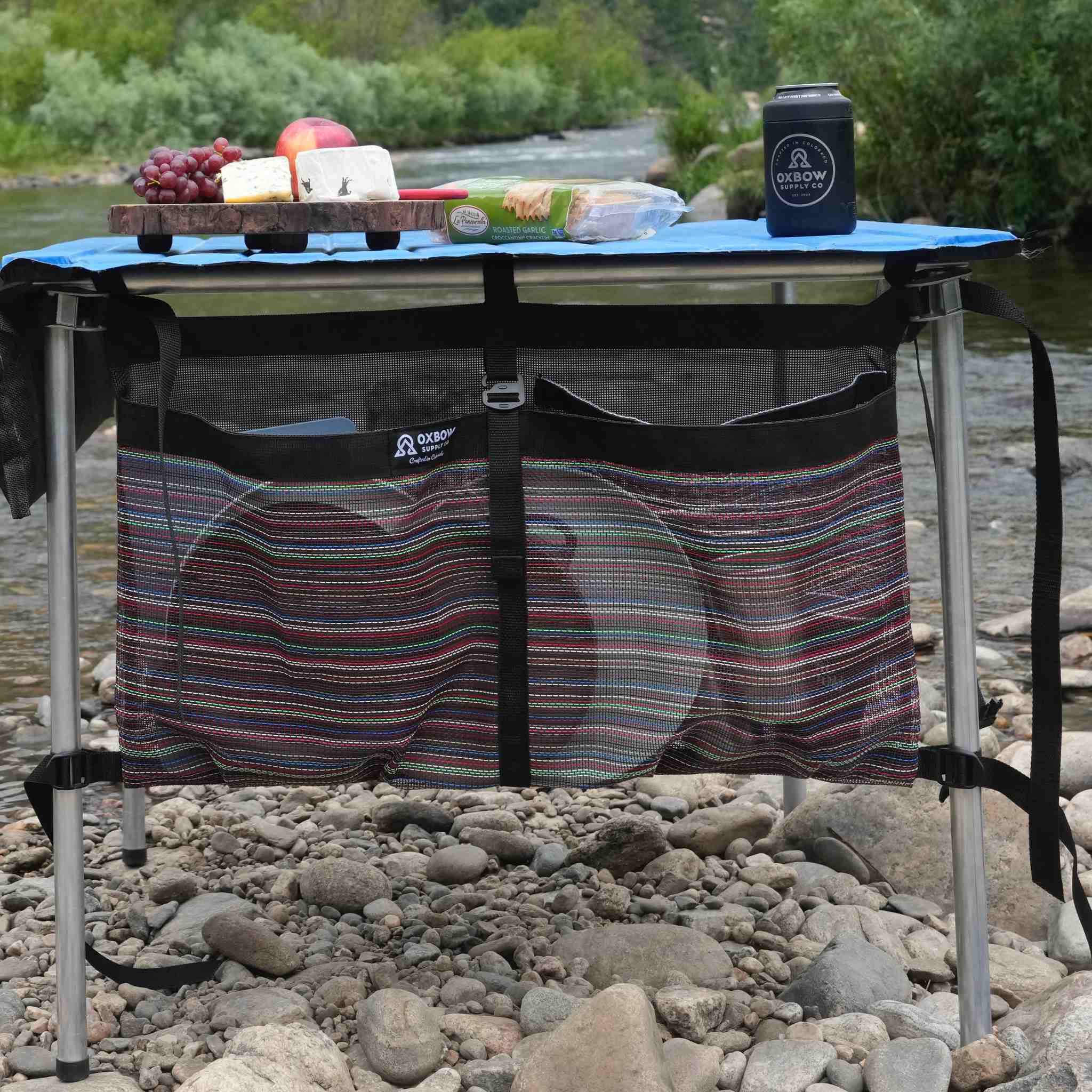 Oxbow Table Caddy mounted beneath folding camp table