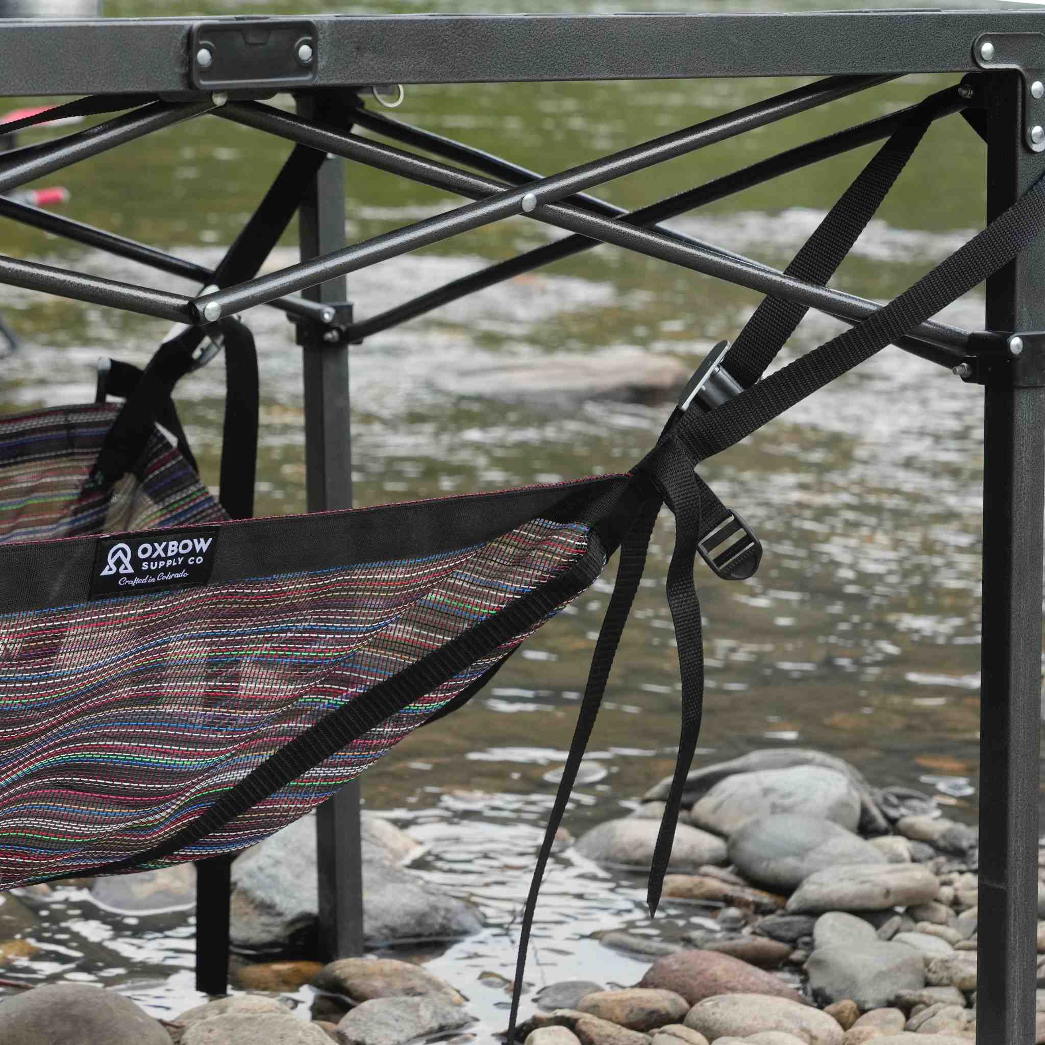 Camp table storage shelf keeping gear off the ground